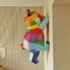 Geometric wall climbing panda sculpture